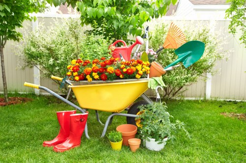 Low-maintenance landscape gardening in Forest Gate with paved areas and evergreens